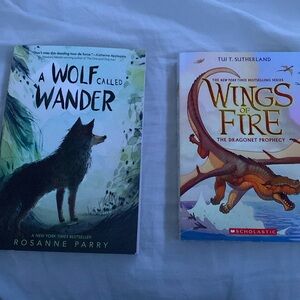 Set of 2 books “ A wolf called wander” and “wings of fire”